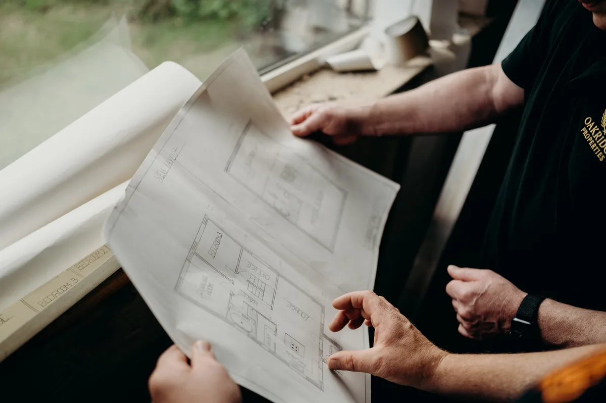 Mike and Davey reviewing the detail of a floor plan