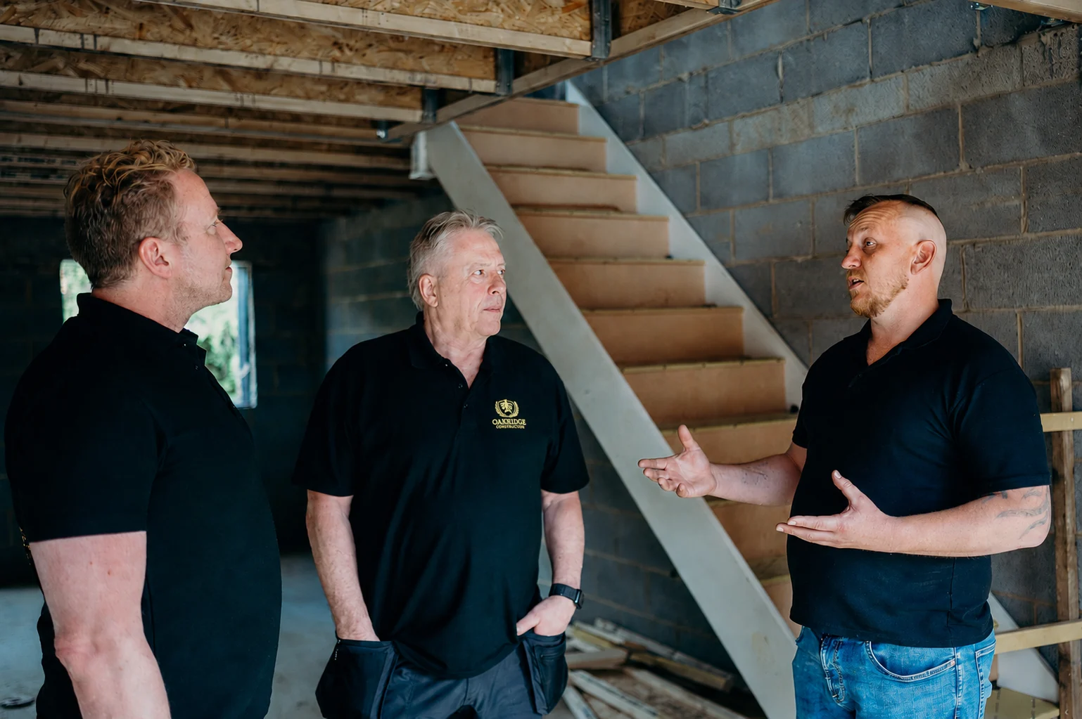 Simon, Mike and Davey discussing a refurbishment on site